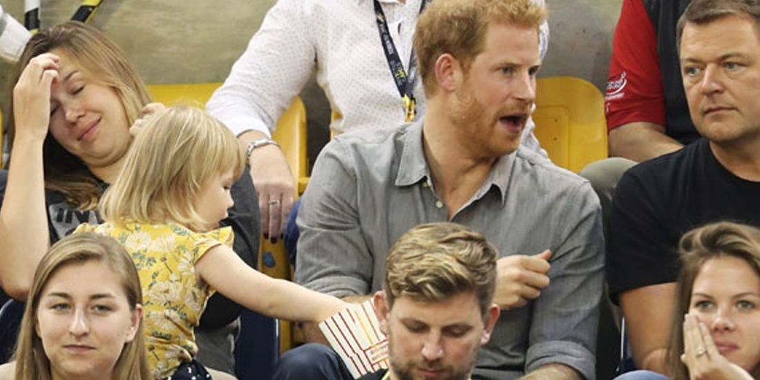 This toddler sneaking popcorn from Prince Harry is all of us